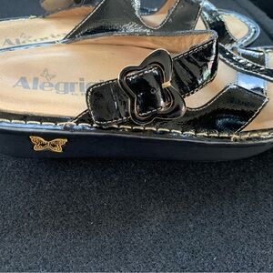 Alegria Shiny Black Sandals with Gold Buckle
